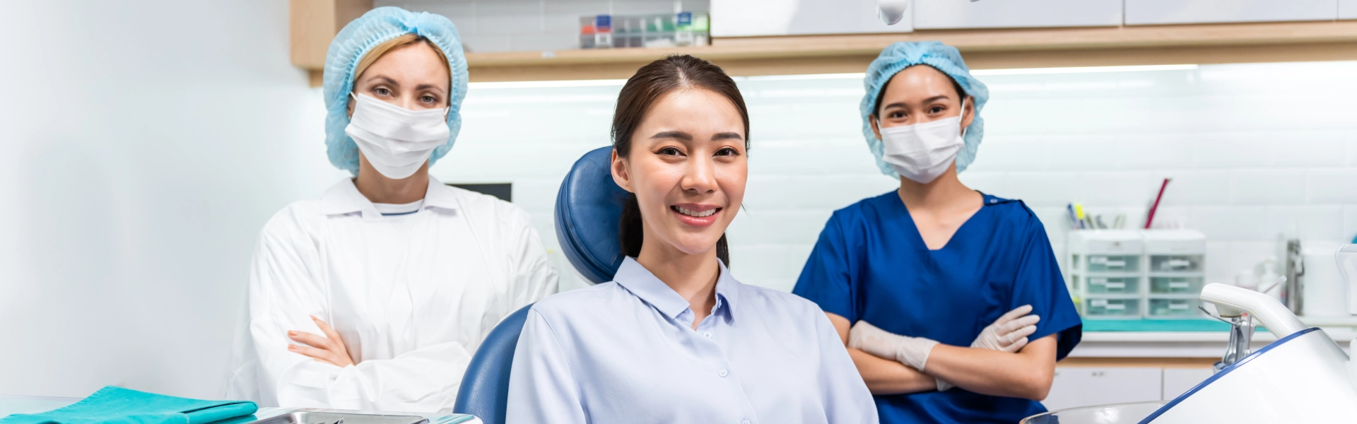 woman in the middle of two dentist